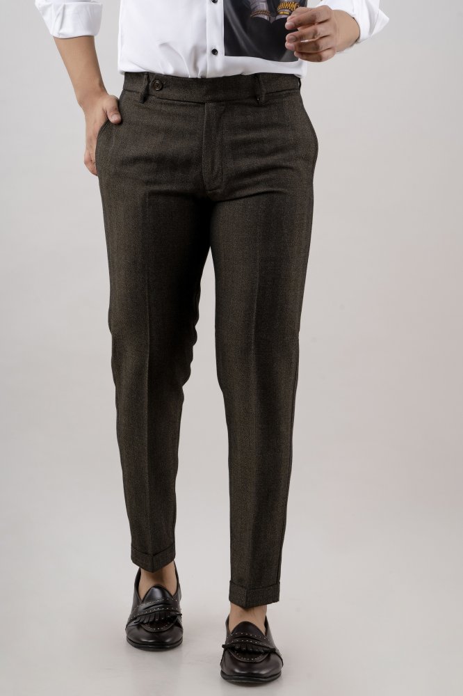 "A pair of neatly pressed tailored pants with a slim-fit design, displayed on a wooden surface."