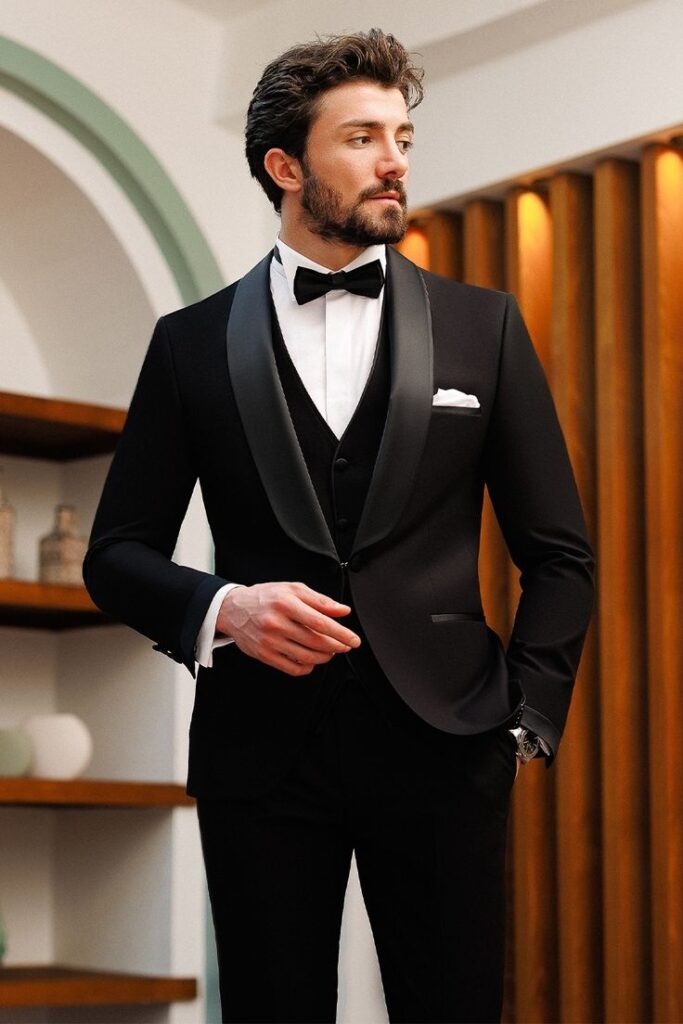 "A classic black tuxedo with a satin lapel, paired with a crisp white dress shirt and a black bow tie."